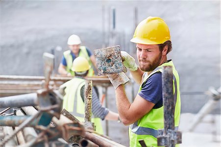 polish ethnicity - Construction worker carrying metal bar at construction site Stock Photo - Premium Royalty-Free, Code: 6113-08321739