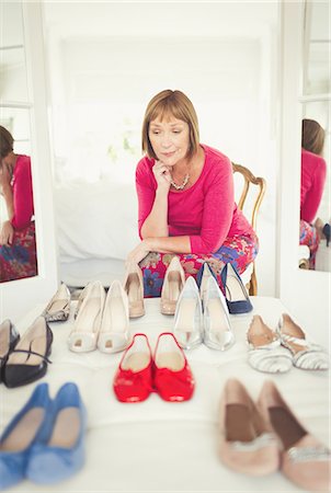 simsearch:649-05521576,k - Indecisive mature woman deciding which shoes to wear in closet Stock Photo - Premium Royalty-Free, Code: 6113-08550089