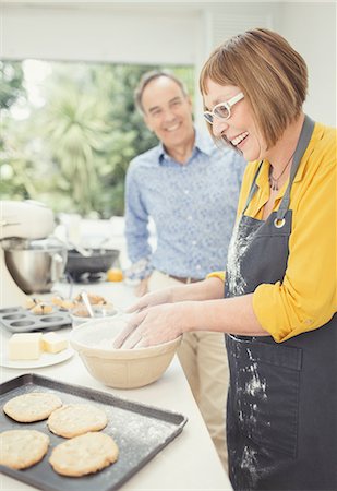 Mature couple baking cookies in kitchen Stock Photo - Premium Royalty-Free, Code: 6113-08550092