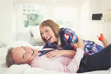 simsearch:6113-07242393,k - Well-dressed mature couple laughing on bed Stock Photo - Premium Royalty-Free, Code: 6113-08550024