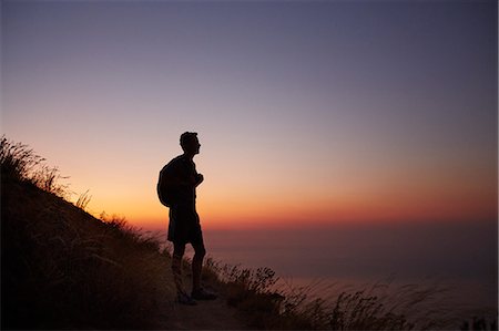 fitness dramatic - Silhouette of male hiker on trail overlooking ocean at sunset Stock Photo - Premium Royalty-Free, Code: 6113-08550172
