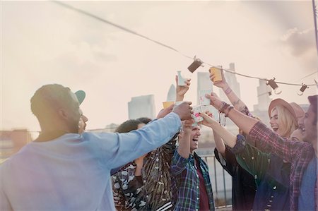 Enthusiastic young adult friends toasting cocktails at rooftop party Stock Photo - Premium Royalty-Free, Code: 6113-08568479