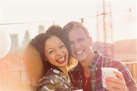 simsearch:6113-07543030,k - Portrait smiling young couple enjoying rooftop party Stock Photo - Premium Royalty-Free, Code: 6113-08568495