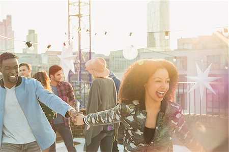 simsearch:6113-07147024,k - Playful young couple at rooftop party Stock Photo - Premium Royalty-Free, Code: 6113-08568597