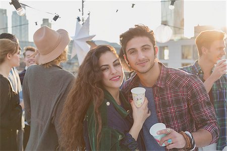 simsearch:6113-07543030,k - Portrait smiling young couple drinking at rooftop party Stock Photo - Premium Royalty-Free, Code: 6113-08568529