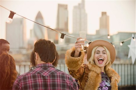 simsearch:6113-07648679,k - Portrait enthusiastic young woman drinking champagne at rooftop party Stock Photo - Premium Royalty-Free, Code: 6113-08568609