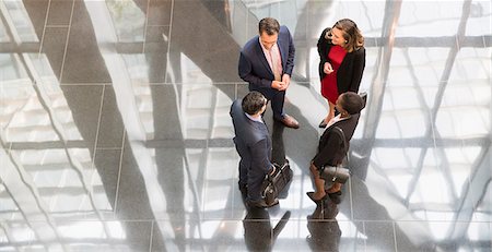 Corporate business people talking in modern office lobby Stock Photo - Premium Royalty-Free, Code: 6113-08568633