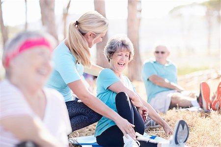 seniors yoga class - Yoga instructor guiding senior woman in sunny park Stock Photo - Premium Royalty-Free, Code: 6113-08568763