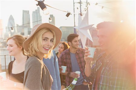 simsearch:6113-07543030,k - Portrait smiling young woman drinking beer at rooftop party Stock Photo - Premium Royalty-Free, Code: 6113-08568704