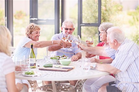 simsearch:6113-07242109,k - Senior adults toasting wine glasses at patio lunch Stock Photo - Premium Royalty-Free, Code: 6113-08568737