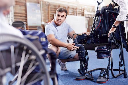 physiotherapist - Physical therapist explaining equipment to man in wheelchair Stock Photo - Premium Royalty-Free, Code: 6113-08521481