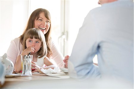 daughter sitting on dad lap - Family at cafe table Stock Photo - Premium Royalty-Free, Code: 6113-08521584