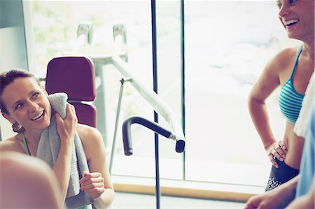 Smiling women resting and talking at gym Stock Photo - Premium Royalty-Free, Code: 6113-08536001