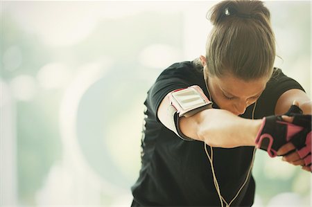 physical activity - Woman with mp3 player armband stretching arms Stock Photo - Premium Royalty-Free, Code: 6113-08536018