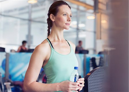 simsearch:6113-07790833,k - Pensive woman drinking water at gym Stock Photo - Premium Royalty-Free, Code: 6113-08536113