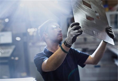 flare - Worker examining piece in steel factory Stock Photo - Premium Royalty-Free, Code: 6113-08655235