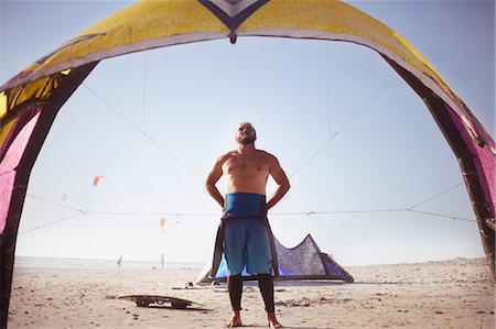 sports events - Man preparing to kiteboard on sunny beach Photographie de stock - Premium Libres de Droits, Code: 6113-08655521