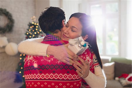 simsearch:700-06553388,k - Grateful girlfriend with Christmas gift hugging boyfriend Stock Photo - Premium Royalty-Free, Code: 6113-08659576