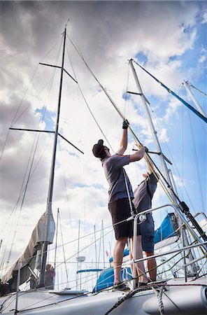 simsearch:614-00602699,k - Men adjusting sailing equipment on sailboat Stock Photo - Premium Royalty-Free, Code: 6113-08698095