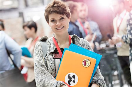 sticker - Portrait smiling young woman with laptop at technology conference Stock Photo - Premium Royalty-Free, Code: 6113-08698008