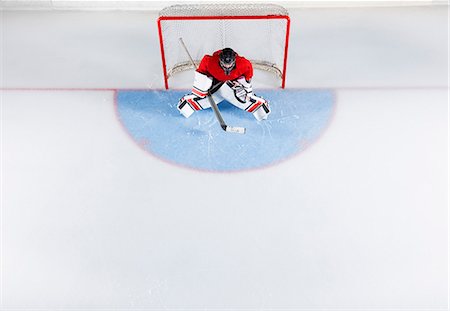 simsearch:6113-08698170,k - Hockey goalie in red uniform protecting goal net Stock Photo - Premium Royalty-Free, Code: 6113-08698156