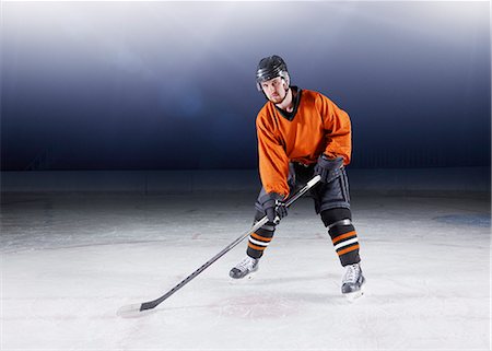 simsearch:6113-08698170,k - Portrait confident hockey player in orange uniform on ice Stock Photo - Premium Royalty-Free, Code: 6113-08698165