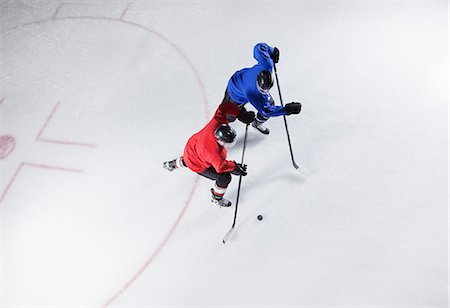simsearch:6113-08698170,k - Hockey players going for the puck on ice Stock Photo - Premium Royalty-Free, Code: 6113-08698174