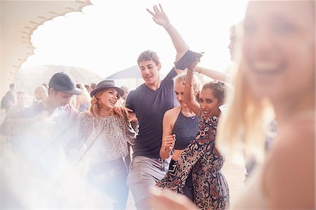 Young friends dancing at music festival Stock Photo - Premium Royalty-Free, Code: 6113-08698277