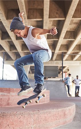 simsearch:649-07710443,k - Teenage boy jumping skateboard at skate park Stock Photo - Premium Royalty-Free, Code: 6113-08698220