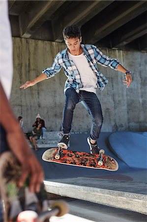 simsearch:649-07710443,k - Focused teenage boy flipping skateboard at skate park Stock Photo - Premium Royalty-Free, Code: 6113-08698222