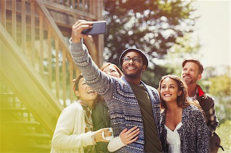simsearch:6113-07565751,k - Smiling friends with camera phone taking selfie outdoors Stock Photo - Premium Royalty-Free, Code: 6113-08743389
