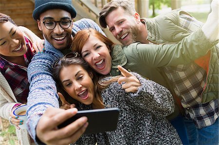 simsearch:6113-08743597,k - Playful friends with camera phone gesturing taking selfie Stock Photo - Premium Royalty-Free, Code: 6113-08743390