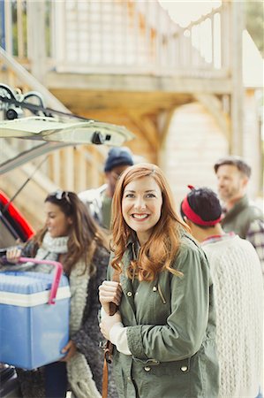 simsearch:6113-08743597,k - Portrait smiling woman with friends unloading cooler from back of car Stock Photo - Premium Royalty-Free, Code: 6113-08743395