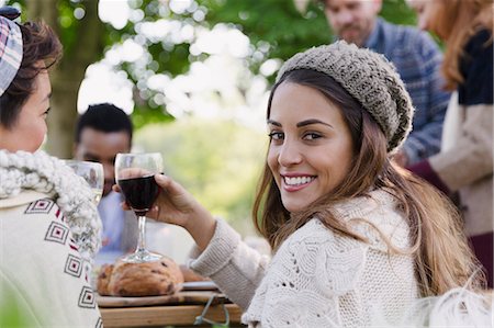 simsearch:6113-08743597,k - Portrait smiling woman drinking wine at patio lunch with friends Stock Photo - Premium Royalty-Free, Code: 6113-08743463