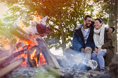 simsearch:6113-07147024,k - Couple hugging by campfire Stock Photo - Premium Royalty-Free, Code: 6113-08743475
