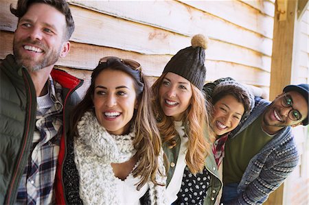 simsearch:6113-08743597,k - Smiling friends standing in a row outside cabin Stock Photo - Premium Royalty-Free, Code: 6113-08743412