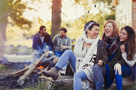 simsearch:6113-08743597,k - Female friends laughing and roasting marshmallows at campfire Stock Photo - Premium Royalty-Free, Code: 6113-08743417