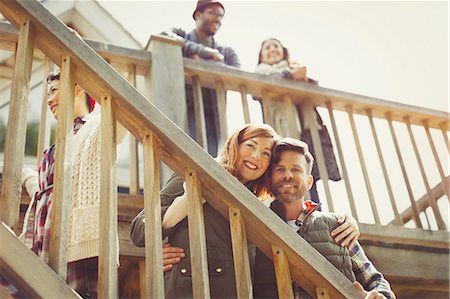 simsearch:6113-07565751,k - Portrait smiling couple on stairs outside cabin Stock Photo - Premium Royalty-Free, Code: 6113-08743430