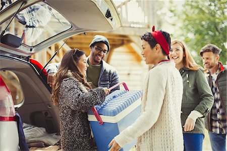 Friends unloading backpack at back of car Stock Photo - Premium Royalty-Free, Code: 6113-08743555