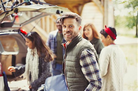 simsearch:6113-08743597,k - Portrait smiling man with friends unloading car Stock Photo - Premium Royalty-Free, Code: 6113-08743556