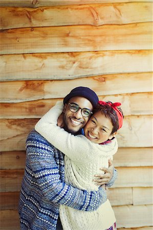 simsearch:6113-08743597,k - Portrait enthusiastic couple hugging and smiling outside cabin Stock Photo - Premium Royalty-Free, Code: 6113-08743568
