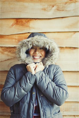 simsearch:6113-08743597,k - Portrait smiling woman wearing fur hood coat outside cabin Stock Photo - Premium Royalty-Free, Code: 6113-08743584