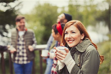 simsearch:6113-08743597,k - Smiling woman drinking coffee on balcony Stock Photo - Premium Royalty-Free, Code: 6113-08743533