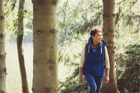 simsearch:6113-08743597,k - Smiling woman hiking in woods Stock Photo - Premium Royalty-Free, Code: 6113-08743537
