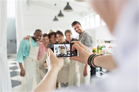 Man photographing cooking class students in kitchen Stock Photo - Premium Royalty-Free, Code: 6113-08743666