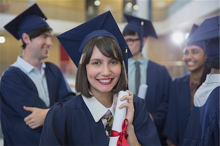 simsearch:6113-07791483,k - Portrait smiling female college graduate in cap and gown holding diploma Stock Photo - Premium Royalty-Free, Code: 6113-08769677