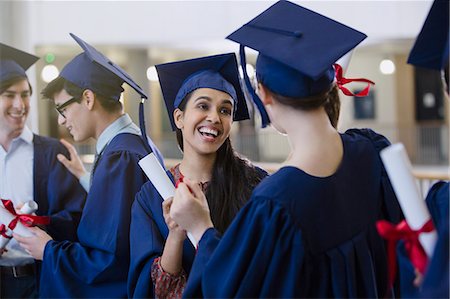 simsearch:6113-07791483,k - Happy female college student graduates with cap and gown and diplomas celebrating Stock Photo - Premium Royalty-Free, Code: 6113-08769623
