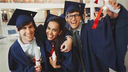 simsearch:6113-07791483,k - Portrait enthusiastic college graduates in cap and gown with diplomas Stock Photo - Premium Royalty-Free, Code: 6113-08769733