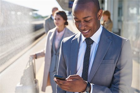 simsearch:700-03058969,k - Businessman texting with cell phone on train station platform Stock Photo - Premium Royalty-Free, Code: 6113-08784262