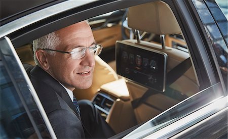 rich man and luxury - Businessman looking out town car window Stock Photo - Premium Royalty-Free, Code: 6113-08784325